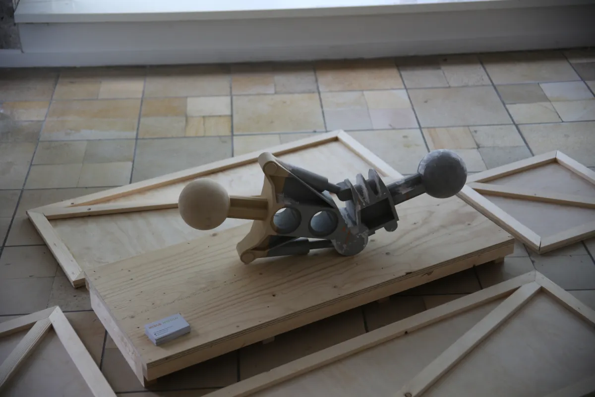 One of the three sculptures from the work Residual Protodermis laid on the floor on top of an art handling crate.